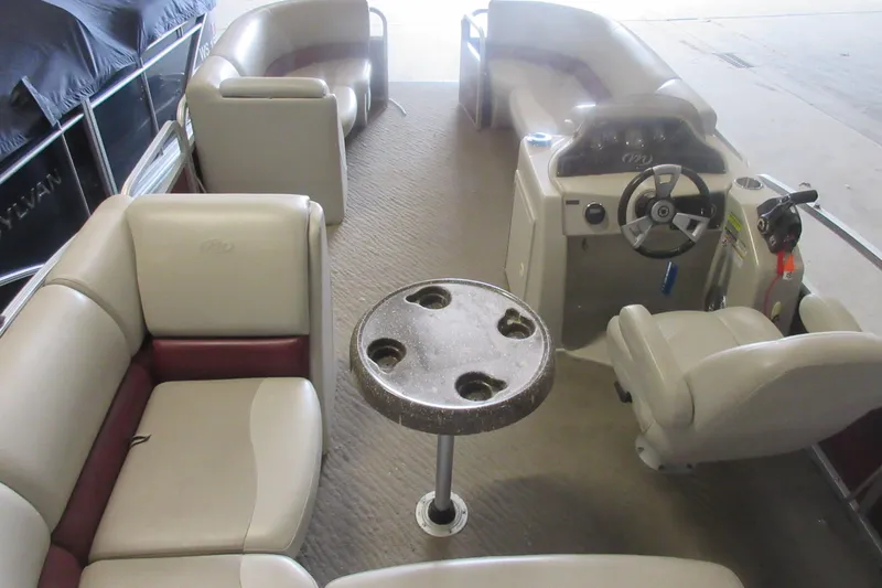 Slide: The Image of Interior of a 2014 Manitou 22 Aurora pontoon boat with seating and steering console. - 3