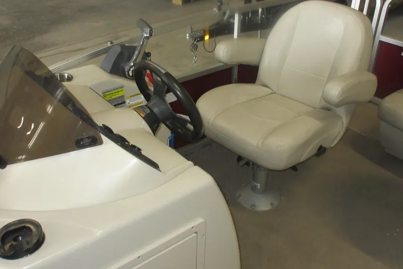 Slide: The Image of Interior of 2014 Manitou 22 Aurora boat showing steering wheel and captain's chair. - 5