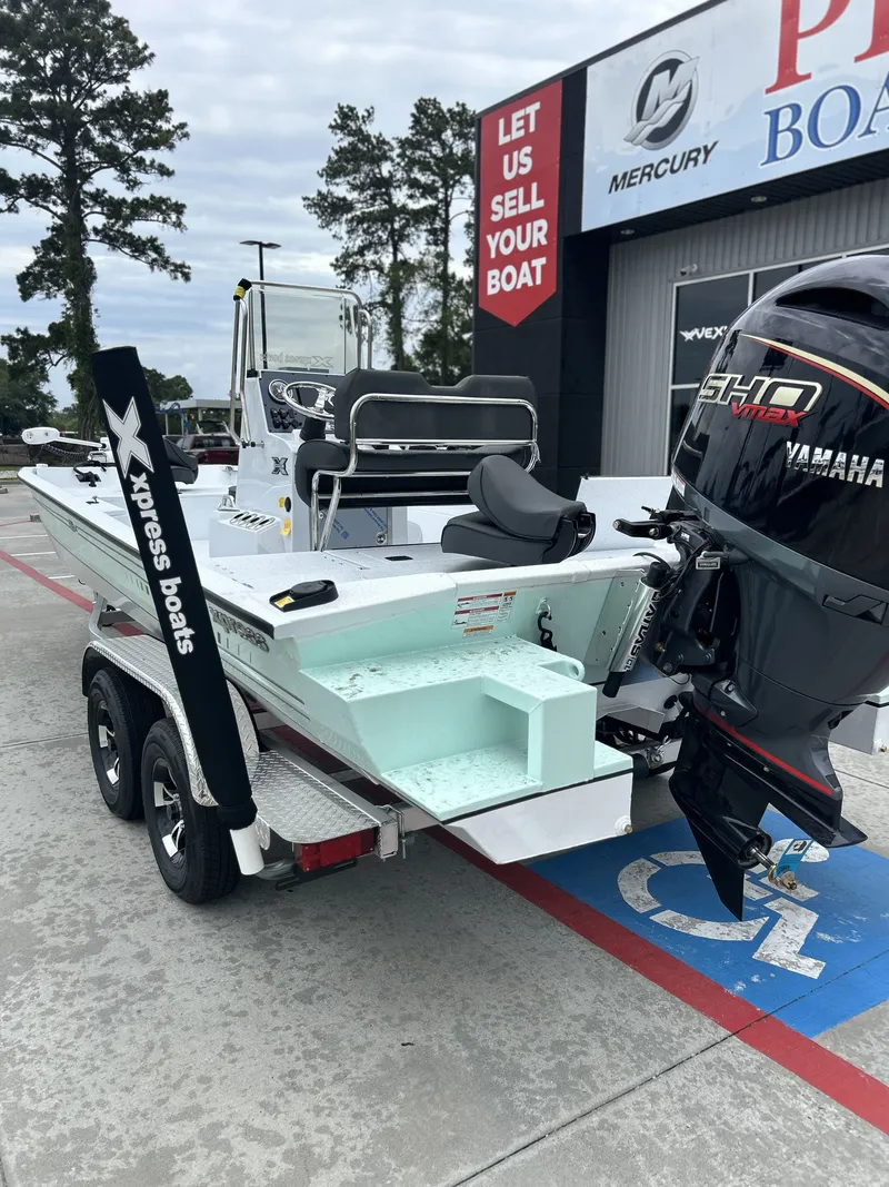 Slide: The Image of 2026 Xpress SW22B boat with Yamaha motor on trailer. - 24