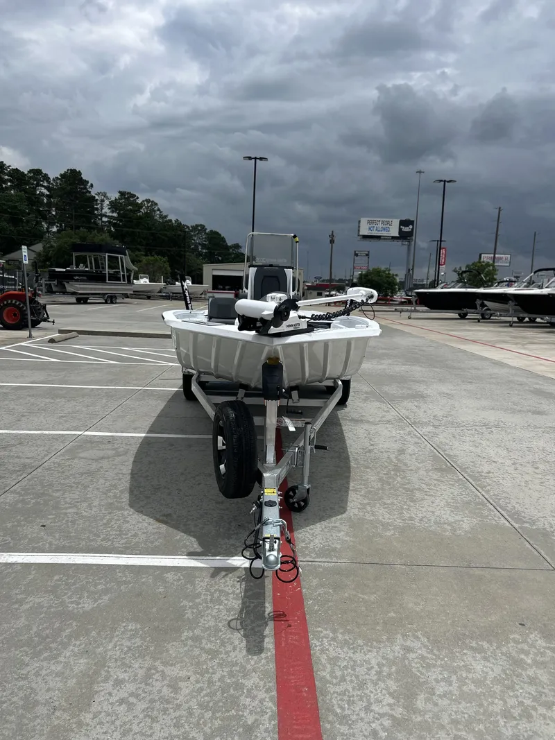 Slide: The Image of 2026 Xpress SW22B boat on trailer under cloudy sky. - 3