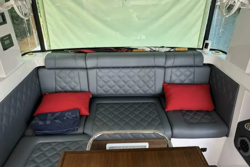 Slide: The Image of Luxurious interior of 2021 Axopar Brabus 37 XC Cross Cabin with gray seating and red cushions. - 14