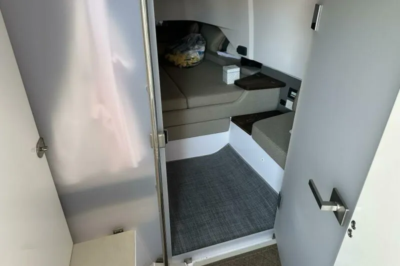 Slide: The Image of 2021 Axopar Brabus 37 XC Cross Cabin interior with cozy seating and modern design. - 17