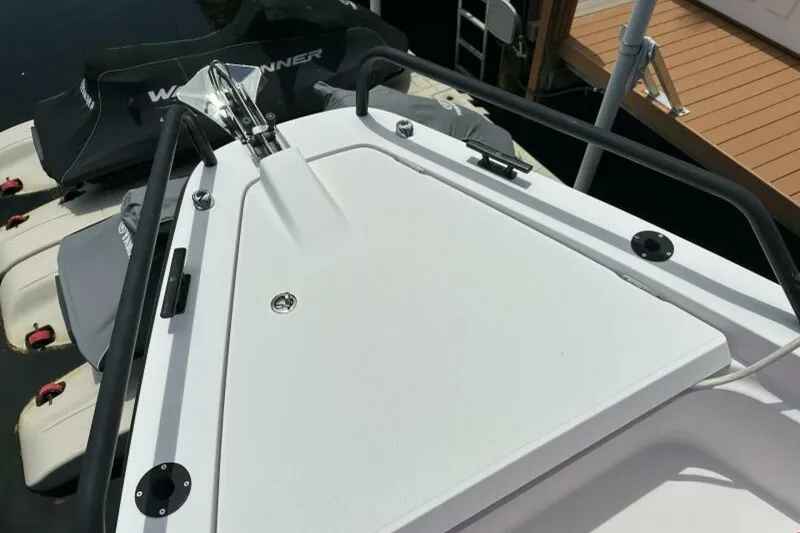 Slide: The Image of 2021 Axopar Brabus 37 XC Cross Cabin boat deck with railing and watercraft nearby. - 20