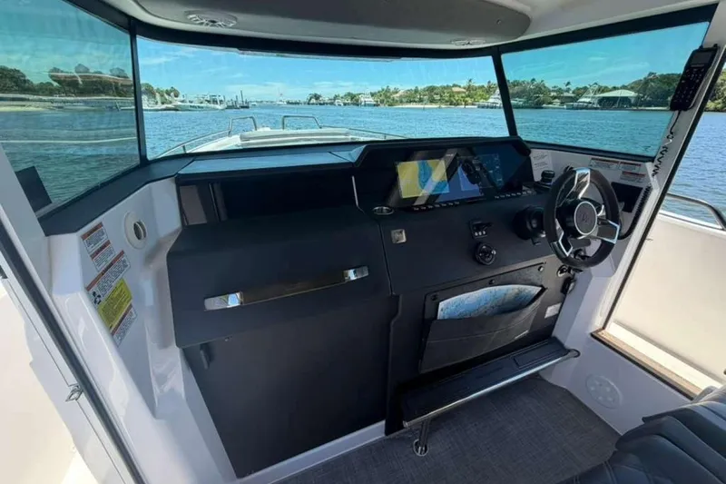 Slide: The Image of Interior view of 2021 Axopar Brabus 37 XC Cross Cabin helm with navigation display. - 23