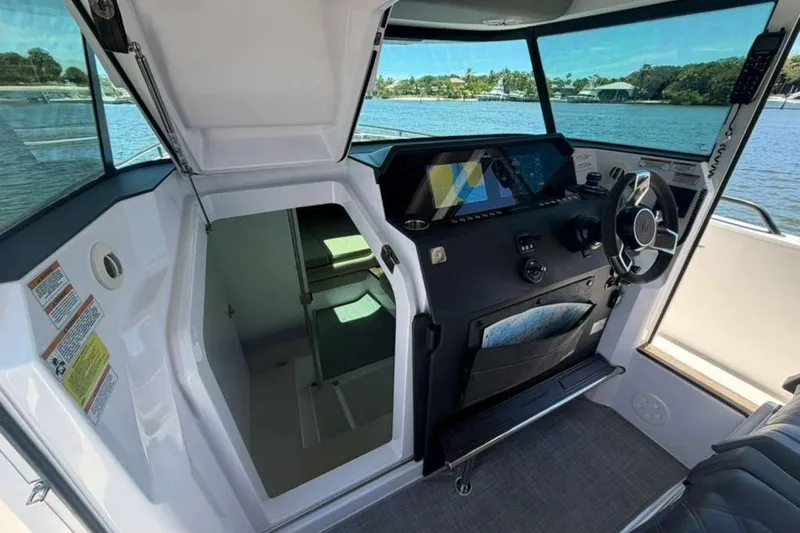 Slide: The Image of Interior of 2021 Axopar Brabus 37 XC Cross Cabin with helm and navigation equipment. - 24