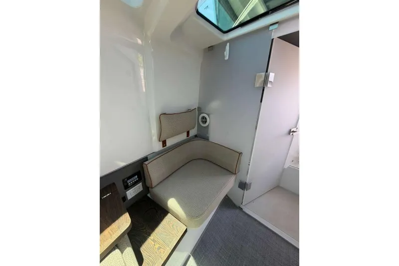 Slide: The Image of 2021 Axopar Brabus 37 XC Cross Cabin interior with cushioned seating and modern design. - 26