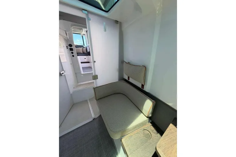 Slide: The Image of Interior of 2021 Axopar Brabus 37 XC Cross Cabin, featuring cozy seating and modern design. - 27
