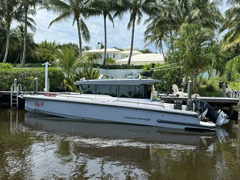 The Image of 2021 Axopar 37 XC Cross Cabin Brabus docked by palm trees. - 3