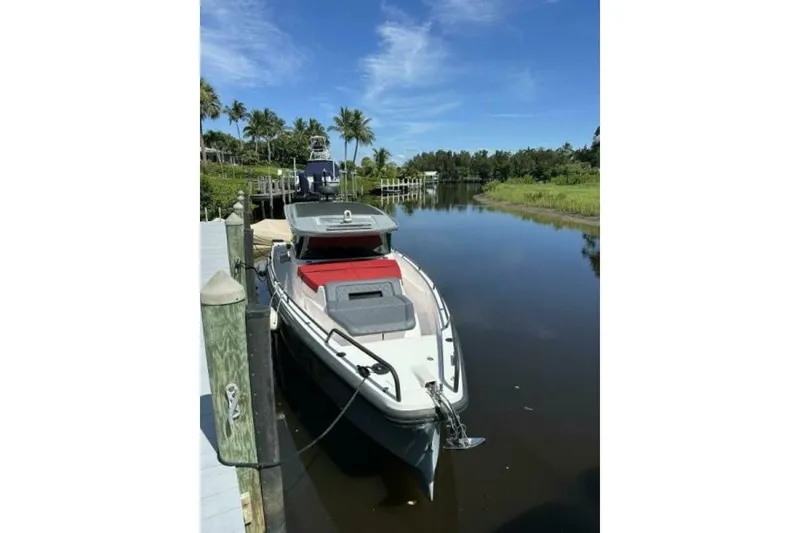 Slide: The Image of 2021 Axopar Brabus 37 XC Cross Cabin docked on a sunny day. - 4