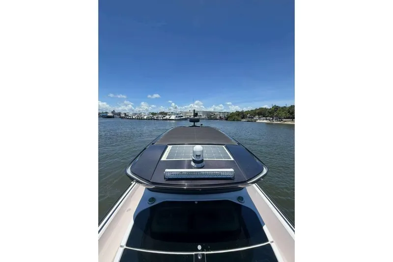 Slide: The Image of 2021 Axopar Brabus 37 XC Cross Cabin on a sunny day, river view. - 42
