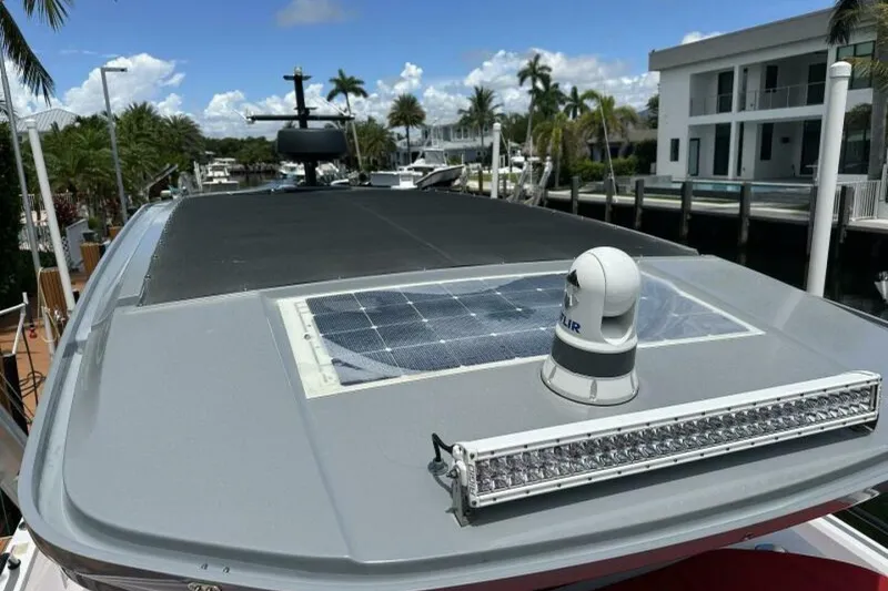 Slide: The Image of 2021 Axopar Brabus 37 XC Cross Cabin with solar panel and radar, docked in marina. - 43