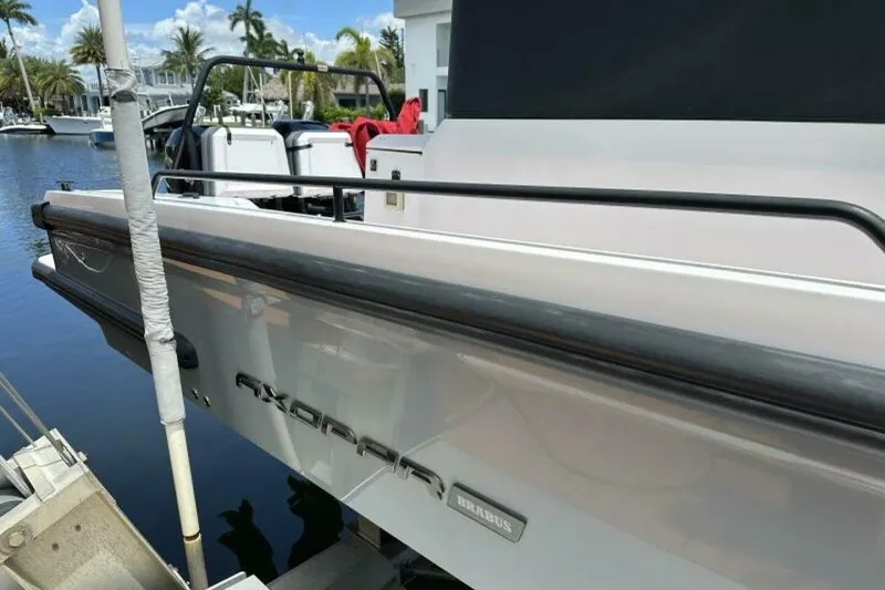 Slide: The Image of 2021 Axopar Brabus 37 XC Cross Cabin docked, showcasing sleek design and luxury features. - 6