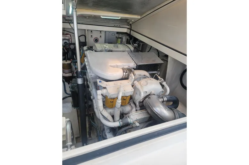Slide: The Image of Engine compartment of a 1999 Cabo 35 Express boat, showcasing mechanical components. - 10