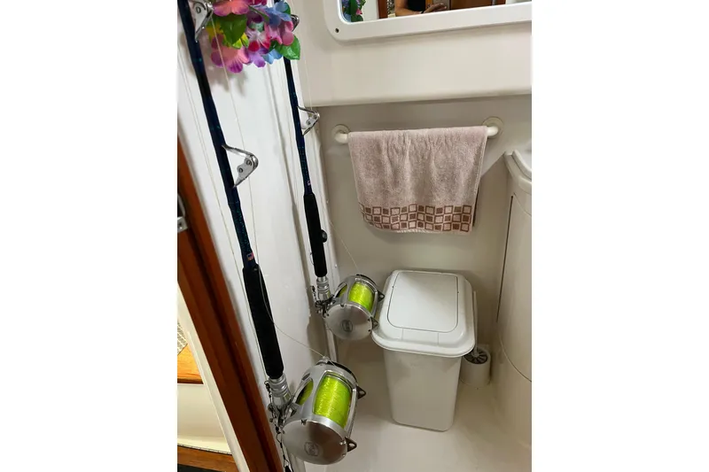 Slide: The Image of Fishing rods and towel in 1999 Cabo 35 Express boat bathroom. - 16