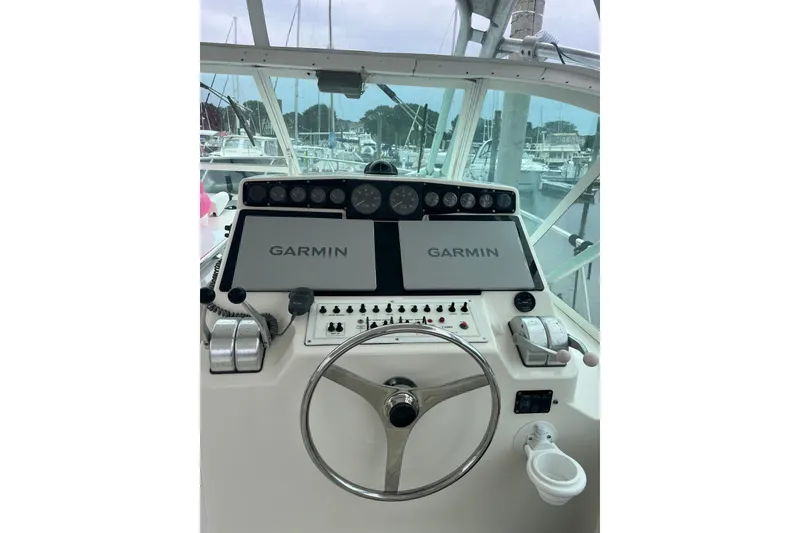 Slide: The Image of Helm of 1999 Cabo 35 Express boat with Garmin navigation displays. - 2
