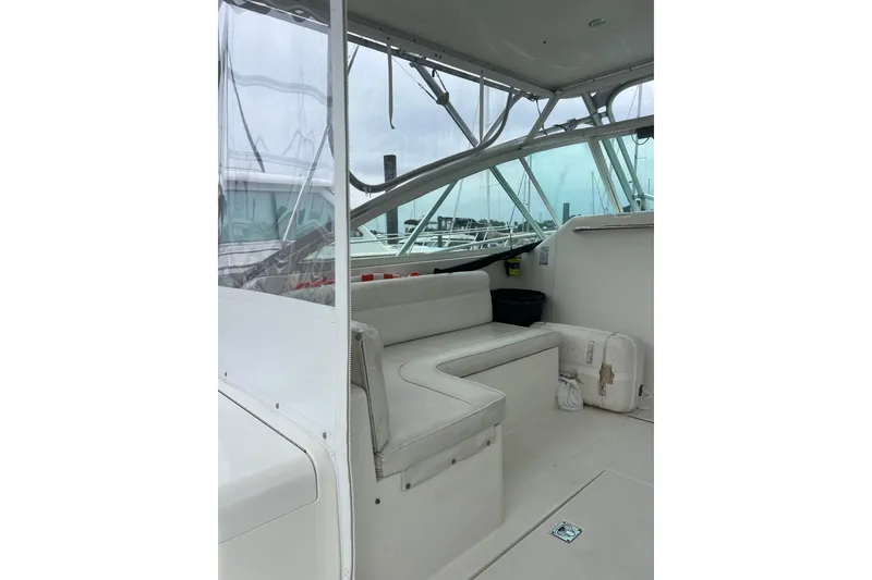 Slide: The Image of 1999 Cabo 35 Express boat interior with white seating and clear windows. - 4