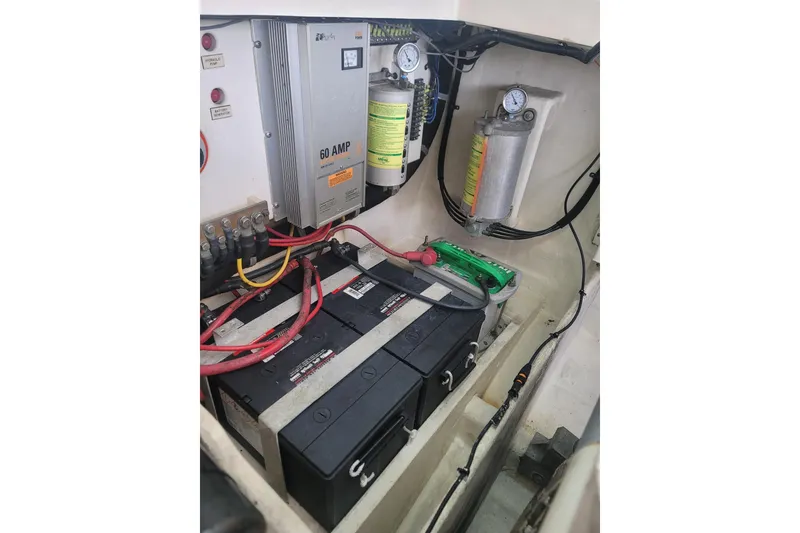 Slide: The Image of Engine compartment of a 1999 Cabo 35 Express boat with batteries and electrical components. - 6
