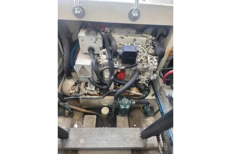 Slide: The Image of Engine compartment of a 1999 Cabo 35 Express boat, showcasing mechanical components and wiring. - 8