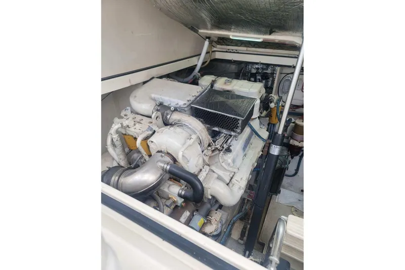 Slide: The Image of Engine compartment of a 1999 Cabo 35 Express boat, showcasing mechanical components. - 9