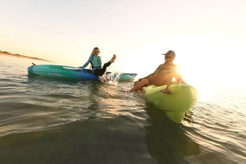 Slide: The Image of Two people kayaking on Ocean Kayak Malibu 11.5 in the sunset, 2023 model. - 10
