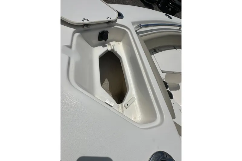 Slide: The Image of 2025 Key West 219 FS boat storage compartment, open lid, white interior. - 10