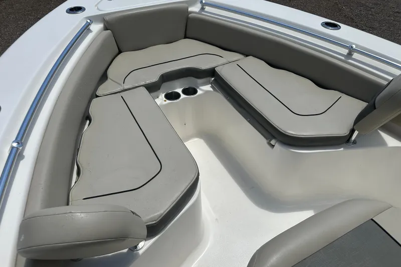 Slide: The Image of 2025 Key West 219 FS boat interior with cushioned seating and cup holders. - 11