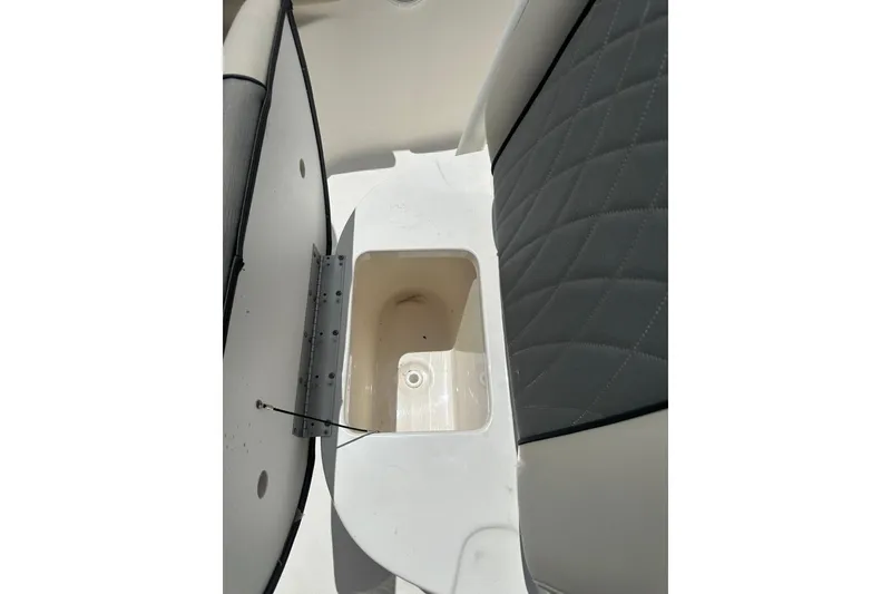 Slide: The Image of 2025 Key West 219 FS boat storage compartment with cushioned seating. - 14