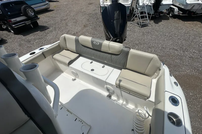 Slide: The Image of 2025 Key West 219 FS boat interior with cushioned seating and motor. - 21