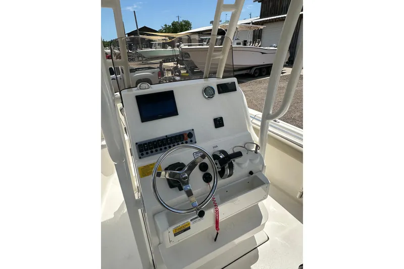 Slide: The Image of 2025 Key West 219 FS boat console with steering wheel and control panel. - 25