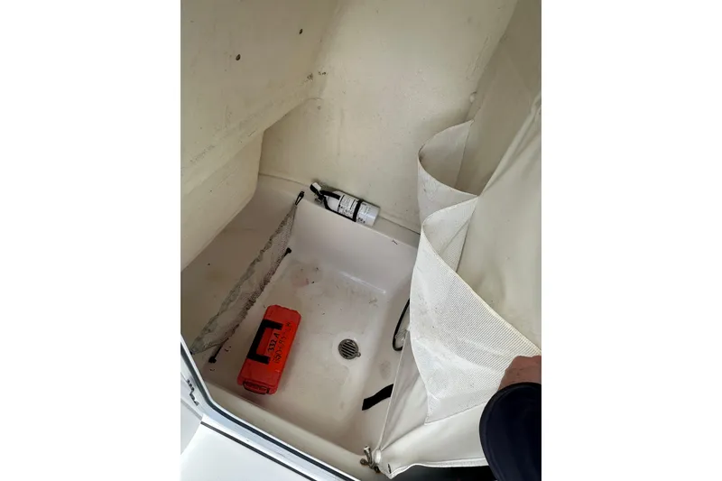 Slide: The Image of Interior of 2025 Key West 219 FS boat, featuring storage area with safety equipment. - 29