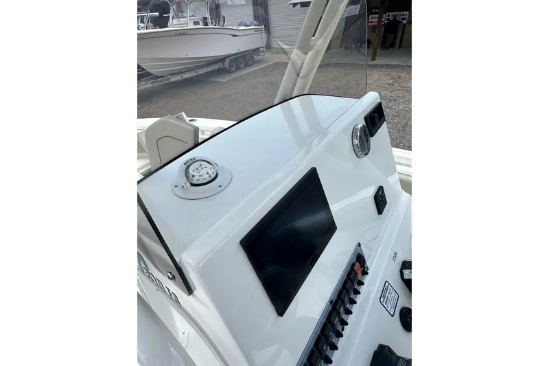 Slide: The Image of 2025 Key West 219 FS boat dashboard with compass and control panel. - 31
