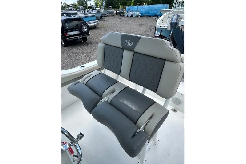 Slide: The Image of 2025 Key West 219 FS boat seating with gray cushioned upholstery and diamond stitching. - 33