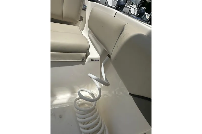 Slide: The Image of 2025 Key West 219 FS boat interior with coiled hose and cushioned seating. - 36