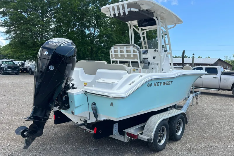 Slide: The Image of 2025 Key West 219 FS boat on trailer, featuring sleek design and powerful outboard motor. - 5