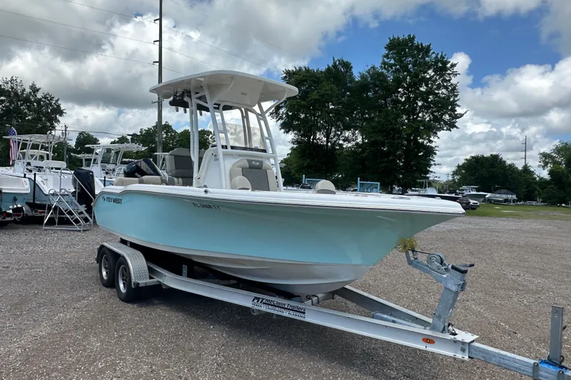 Slide: The Image of 2025 Key West 219 FS boat on trailer, parked outdoors under cloudy sky. - 8
