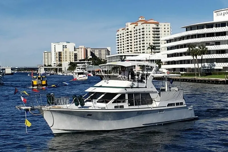 Slide: The Image of 1993 Tollycraft 45 Cockpit Motor Yacht cruising near waterfront buildings. - 1