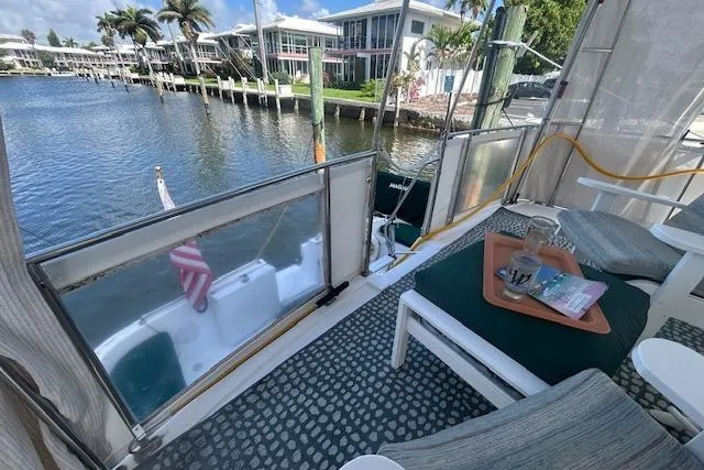 Slide: The Image of 1994 Tollycraft 45 Cockpit Motor Yacht with waterfront view and cozy seating area. - 11