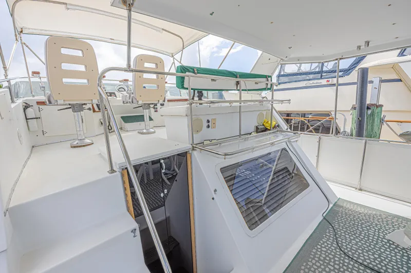 Slide: The Image of 1994 Tollycraft 45 Cockpit Motor Yacht interior with helm chairs and cockpit view. - 12