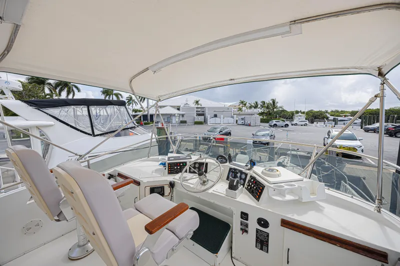 Slide: The Image of 1994 Tollycraft 45 Cockpit Motor Yacht helm with dual seats and control panel. - 13