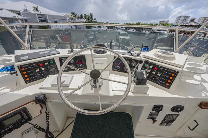 Slide: The Image of Cockpit view of 1994 Tollycraft 45 Cockpit Motor Yacht with steering wheel and control panels. - 16