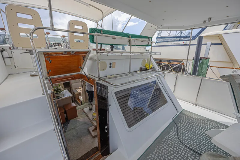 Slide: The Image of 1994 Tollycraft 45 Cockpit Motor Yacht interior with open cabin door and seating area. - 17