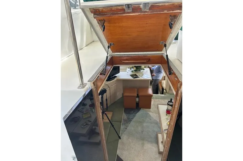 Slide: The Image of Interior view of 1994 Tollycraft 45 Cockpit Motor Yacht, featuring open hatch and cozy seating area. - 18