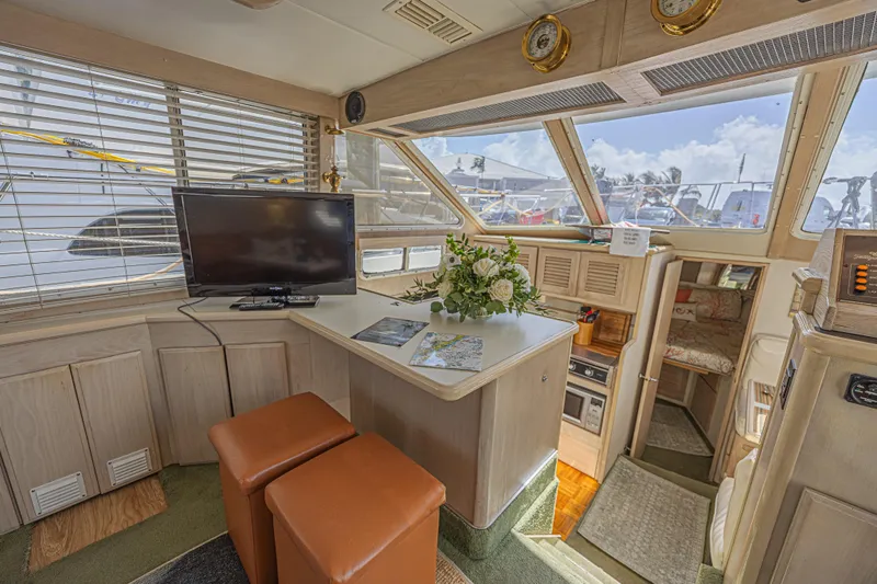 Slide: The Image of Interior of 1994 Tollycraft 45 Cockpit Motor Yacht with TV, seating, and floral arrangement. - 19