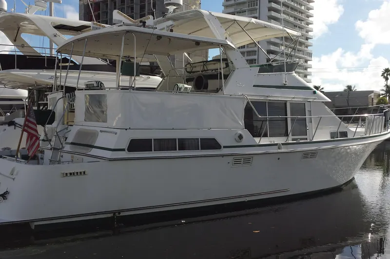 Slide: The Image of 1993 Tollycraft 45 Cockpit Motor Yacht docked in marina, side view. - 2