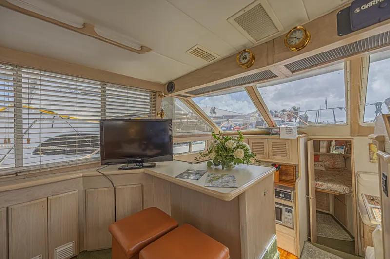 Slide: The Image of Interior of 1994 Tollycraft 45 Cockpit Motor Yacht with TV, flowers, and seating. - 20