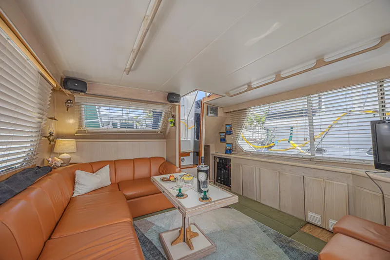 Slide: The Image of Luxurious interior of 1994 Tollycraft 45 Cockpit Motor Yacht with leather seating and large windows. - 22