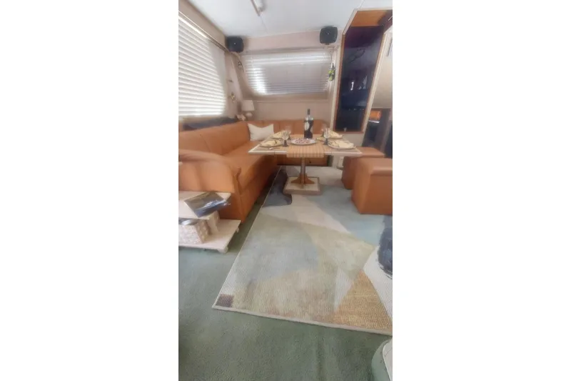 Slide: The Image of Luxurious interior of 1994 Tollycraft 45 Cockpit Motor Yacht with dining setup. - 28