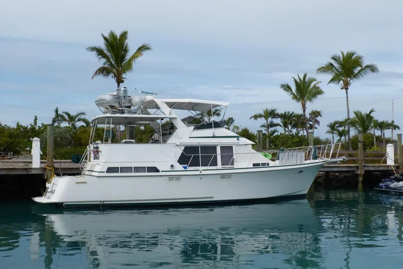 Slide: The Image of 1993 Tollycraft 45 Cockpit Motor Yacht docked near palm trees. - 3