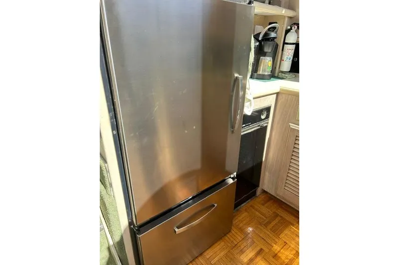 Slide: The Image of Stainless steel refrigerator in a 1994 Tollycraft 45 Cockpit Motor Yacht kitchen. - 33
