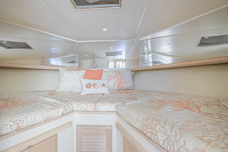 Slide: The Image of Cozy cabin interior of 1994 Tollycraft 45 Cockpit Motor Yacht with coral-themed bedding. - 35